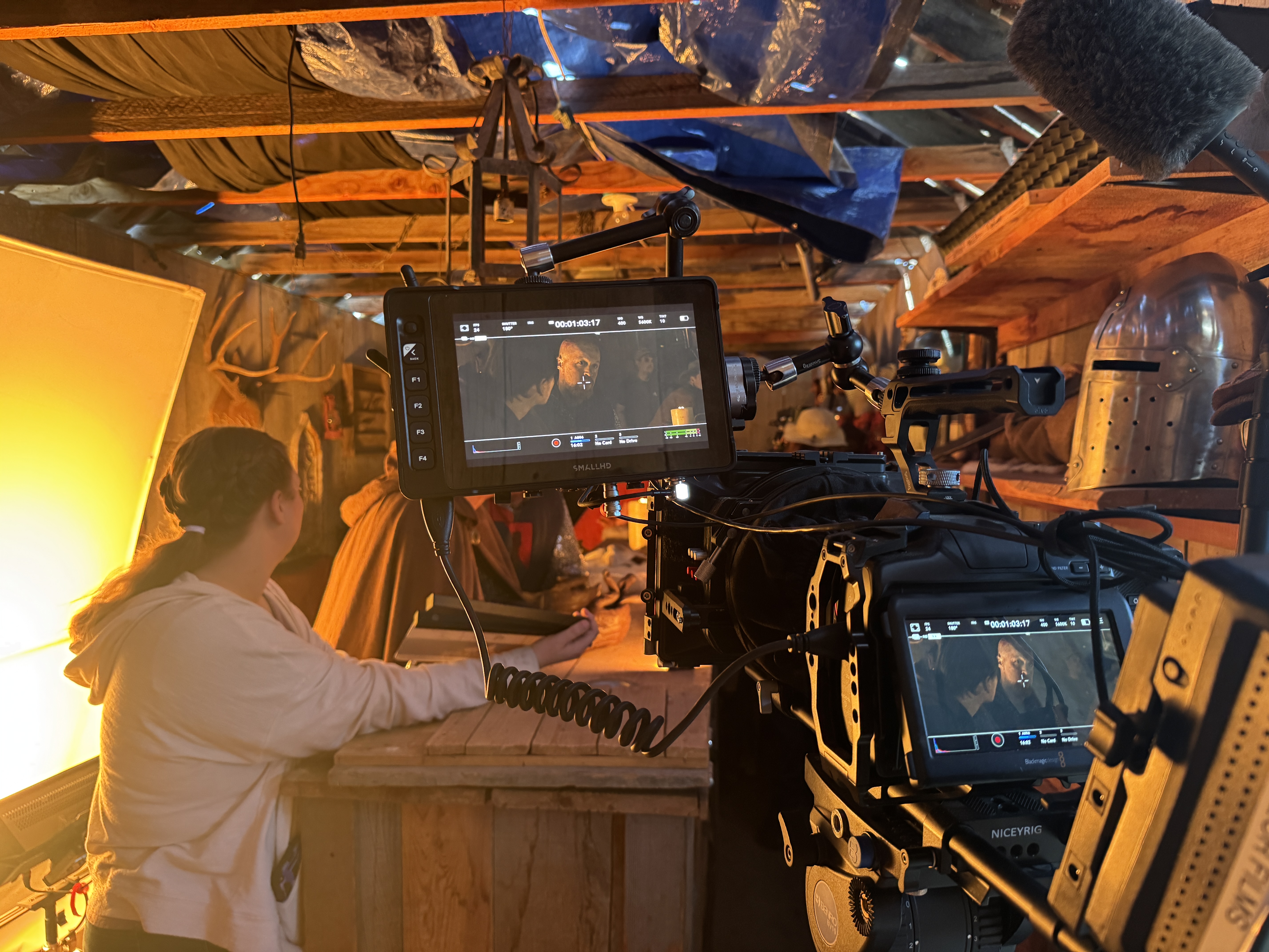 Cinema camera and monitor filming inside a warm practical set